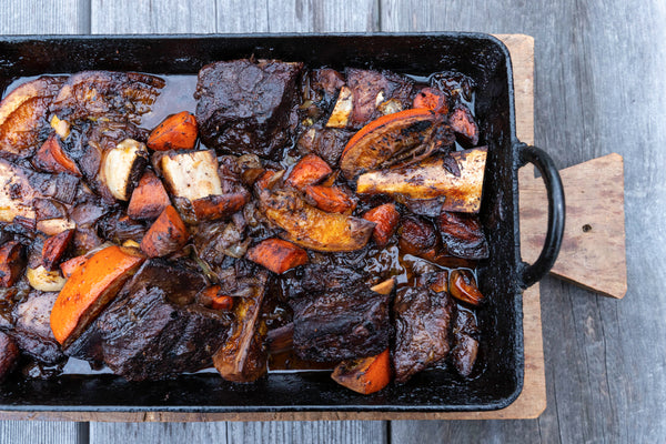 braised short ribs and orange in a pan