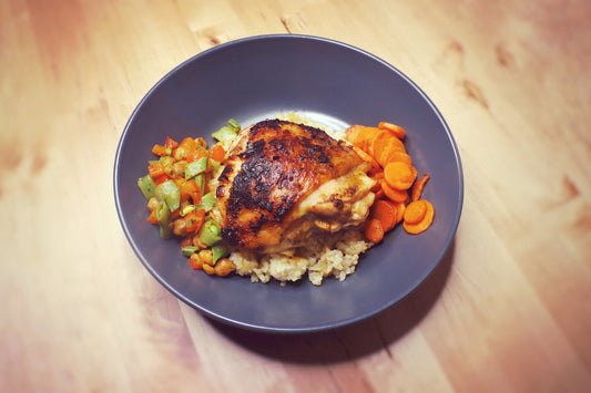 chicken thigh and vegetables over rice