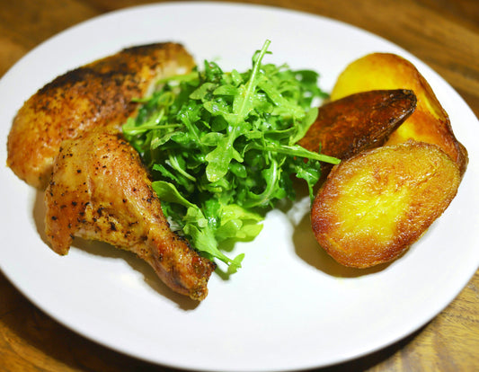 chicken, arugula salad, and crispy potatoes