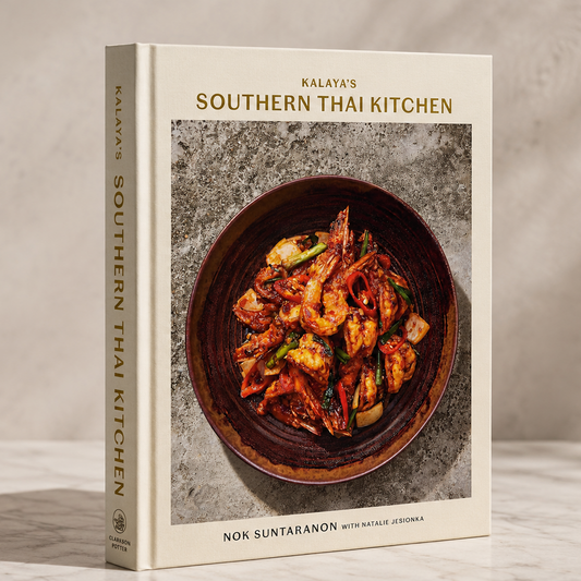 Cookbook titled 'Southern Thai Kitchen' by Non Suntaranon on a wooden surface with a neutral background